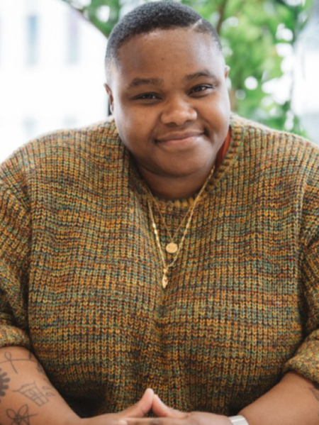 Joy Gharoro-Akpojotor, a person with short black hair wears a knitted pullover.